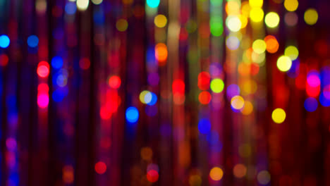 Shot-Of-Defocused-Tinsel-Curtain-In-Night-Club-Or-Disco-With-Reflected-Sparkling-Lights